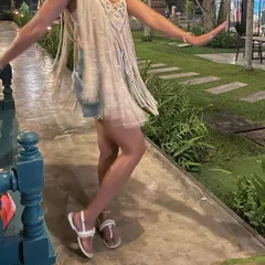 Here I am, enjoying a beautiful evening in my handmade macrame cape. I designed it to be a versatile piece, perfect as a beach cover-up over a swimsuit or styled as a top with shorts for a night out.