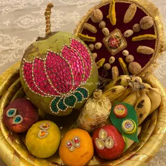 A close-up of an Oti basket featuring a coconut decorated with a beautiful pink lotus design made of kundan stones. We can customize these designs based on your theme.