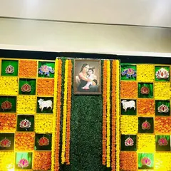 A full view of the marigold checkerboard backdrop, a popular choice for traditional ceremonies like baby showers and haldi events.