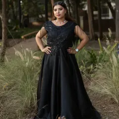 This black off-shoulder gown with fringe sleeve details is perfect for a cocktail party. It’s a modern and stylish option available for rent.