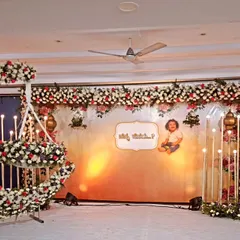 We created this grand floral stage for a naming ceremony, featuring a stunning moon-shaped cradle made of fresh flowers. The custom backdrop and candle-like lights add a touch of magic to the occasion.