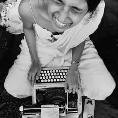 A moment of pure, unbridled joy captured between poems. This is me in my element, surrounded by nature, with my trusted typewriter, doing what I love most. This black and white photo perfectly captures the timeless feeling of creating art from the heart.