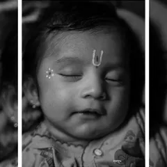 A peaceful black and white close-up of a baby during his Janmashtami shoot. The focus on his serene, sleeping face with the traditional 'tilak' creates a timeless and angelic portrait.
