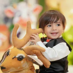 The birthday boy enjoying a ride on a toy deer. Capturing these moments of play and imagination is a key part of my event photography service.