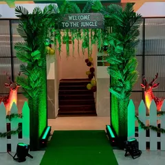 This "Welcome to the Jungle" entrance immediately immerses guests in the party theme. I used green turf, leafy columns, and animal props to create an exciting entryway.