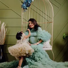 Such a sweet moment between mother and daughter during their family maternity shoot. The little one is helping her mommy get ready, showing the loving bond they share.