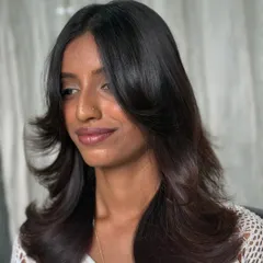 A side view of this refreshing cut. The soft, face-framing layers and healthy, glossy finish give the hair a new lease on life.