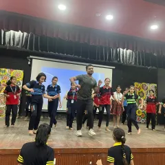 Leading a dance workshop on stage for a school event. I love sharing the joy of dance with a wider community.