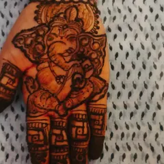 A close-up of a Ganesha portrait on the palm. I love focusing on the details to capture the divine expression and traditional iconography.