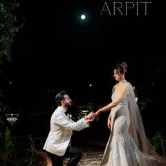 A magical proposal under the moonlight. This silhouette shot is incredibly romantic and highlights the intimacy of the moment.