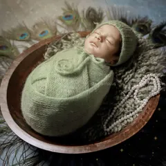 A beautiful portrait from our Little Krishna theme, with the baby swaddled in green and surrounded by peacock feathers and pearls. This is a popular and elegant cultural theme.