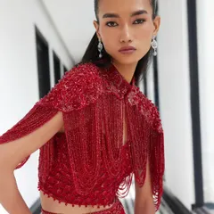 A knockout look for a cocktail evening, this red crystal-embellished cape and satin slit skirt is pure drama and luxury. The cascading beadwork creates spectacular movement with every step.