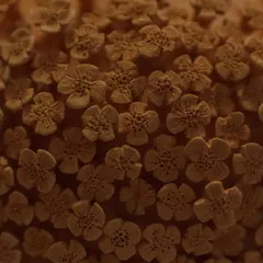 Here is the floral vase after its first firing, known as a bisque. The intricate details of the unglazed clay flowers are so beautiful on their own, it almost feels a shame to glaze it.