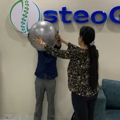I believe in active recovery. Here, I am guiding a patient through a core strengthening exercise with a stability ball, ensuring proper form to maximize benefits and prevent further injury.