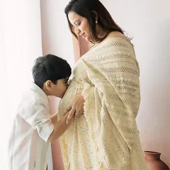 A moment of pure love and anticipation. An older brother gently kisses his mother's belly, already forming a bond with the sibling he is yet to meet. My maternity sessions focus on these unscripted, heartfelt interactions that tell the story of a growing family.