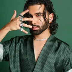 A close-up portrait of Orry from our GQ Best Dressed shoot. The focus here is on the attitude and the details: the wet-look hair, the diamond necklace, and the statement rings that complete his signature style.