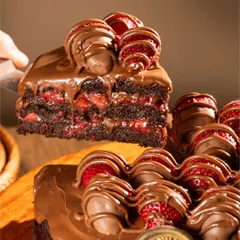 Look at the layers in our classic Nutella Strawberry cake. You can see the rich chocolate sponge, the bright red of our homemade strawberry compote, and the chocolate-dipped strawberries on top.