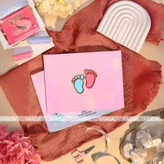 A sweet and simple baby shower invitation featuring the adorable motif of tiny baby feet in pink and blue. The minimalist design on a soft pink card is a charming way to announce the upcoming arrival.