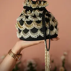 For a touch of classic glamour, the Ameera Black Potli Bag is a perfect choice. The scalloped pearl and gold beadwork against the black fabric creates a timeless and sophisticated look for any evening affair.