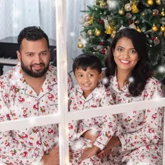 Cozy and together is the best way to be at Christmas. This family portrait in matching pajamas captures the warmth and love of the holiday season.