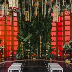 The inner sanctum of the mandap, where a wall of lush banana leaves and traditional brass lamps create a sacred space for the wedding rituals. This design focuses on bringing natural, auspicious elements to the forefront.