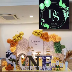 A closer look at a jungle-themed first birthday setup. Notice the large "ONE" prop, custom marquee letters spelling the name, and character cutouts like the giraffe and sheep, all designed to create an immersive safari experience.