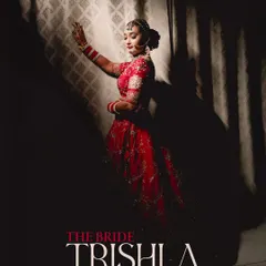 An artistic and dramatic portrait of the bride, "Trishla." The use of shadow and light creates a powerful silhouette, highlighting her pose and adding a touch of mystery and elegance to her bridal look.