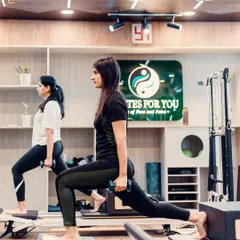 Dumbbell lunges on the Reformer add a strength-training element to a classic Pilates move. This full-body exercise tones the legs, glutes, and arms all at once.