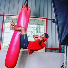 A strong core is your armor in a fight. We incorporate unconventional exercises like these heavy bag crunches to build the abdominal strength required to absorb body shots and power your own strikes.