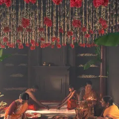 This wide shot shows the beautiful setup for the 'Little Rituals' campaign. The art direction, with the floral ceiling and kolam floor art, created a sacred space for the story of the bridal saree.