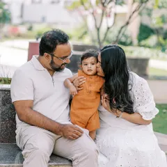 A mother gives her son a sweet kiss on the cheek. These simple, loving gestures create the most heartfelt family portraits.