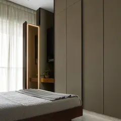 A static view of the ultra-slim sliding dresser in the Taupe Bedroom. When closed, it integrates perfectly with the custom wardrobe, and when open, it provides a fully functional, illuminated vanity without taking up valuable floor space.