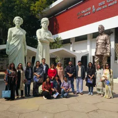 Our students gather for a photo at the Lalit Kala Gallery, in front of the iconic sculptures of Ram V. Sutar.