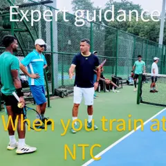 Expert guidance is key to player development. This image captures a moment of on-court strategy discussion between me and our players during a training session at NTC.