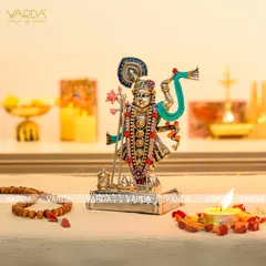 This intricately detailed silver-plated Shrinathji idol is a masterpiece of devotional art. The colorful embellishments and fine craftsmanship make it a stunning addition to any spiritual collection or home decor.