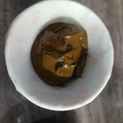 To get that perfectly smooth consistency, I strain my henna paste through a fine cloth. This step removes any tiny lumps from the powder, guaranteeing that the paste will not clog the cone. It is a vital part of my quality promise.