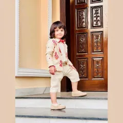 A stylish pose from a young model in my custom beige suit. This shows how I tailor my designs to make kids feel confident and special.