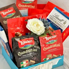 An indulgent hamper for the discerning palate, featuring an assortment of Loacker Quadratini wafers and a bar of Lindt Les Grandes chocolate. A perfect gift for clients with a sweet tooth.