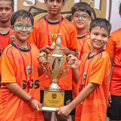 The young SGS Thunder Roarers proudly holding their championship trophy. Our tournaments give even the youngest players a taste of victory.