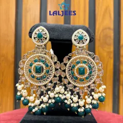 Stunning circular chandbalis with green stones and pearl drops. A perfect statement piece for a Mehendi function.