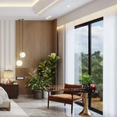 A peaceful reading corner by the window, featuring a comfortable armchair and a side table. The large windows flood the room with natural light and offer a view of the greenery outside.