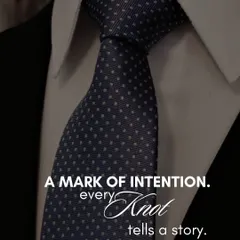 A tie is more than a formality; it is a mark of intention. This close-up of a perfectly knotted navy blue tie with subtle white polka dots illustrates our belief that every detail, no matter how small, contributes to the story your style tells.