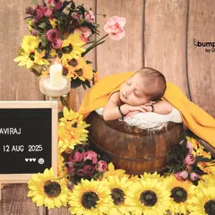 Welcoming baby Aviraj with a burst of sunshine. This newborn is nestled in a wooden bucket surrounded by bright sunflowers, with a letterboard announcing his arrival.
