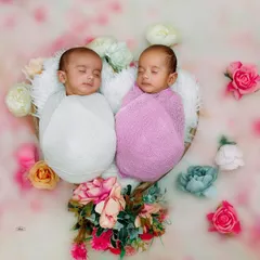 Double the blessing, double the joy. We carefully posed these sleeping newborn twins together in a heart-shaped basket, surrounded by soft flowers, to create a beautiful and symmetrical portrait.
