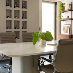This conference room for Office G-2 in Noida was designed for clarity and focus. We prioritized natural light and a neutral color scheme, creating a bright, professional setting complemented by a custom-built wall niche for displaying company achievements.
