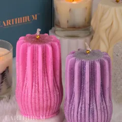 These ribbed pillar candles, shown here in pink and purple with a touch of glitter, are perfect for adding a bit of sparkle to your space.