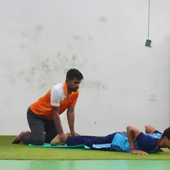 We've always got your back. This sequence shows a trainer assisting a player through a difficult back and core exercise.