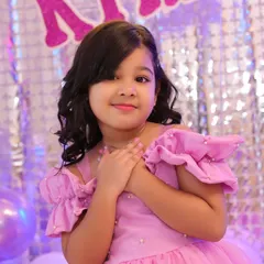 A sweet portrait of the birthday girl, Kyra, against a festive party backdrop. We take time to get those classic shots amidst the day's excitement.