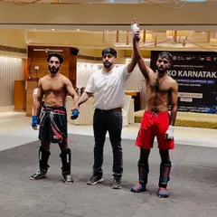 The result of dedication and hard work. Here, one of our UMC warriors has his hand raised in victory at the State Level Kickboxing Championship, a testament to our competition-focused training.