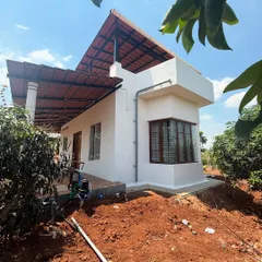 This side view highlights the home's clean geometric lines and the contrast between the white walls and the dark-framed windows. Even in a modern design, we ensure the home sits comfortably in its natural surroundings.
